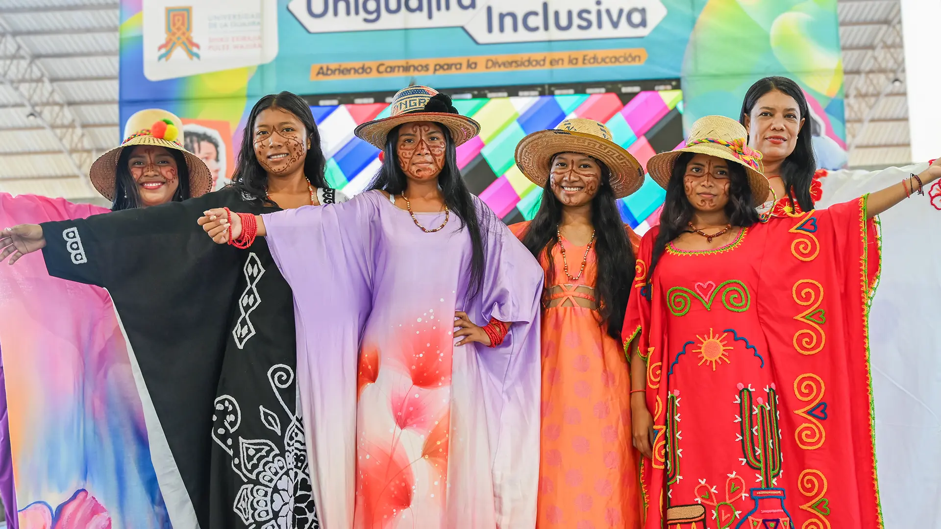 Grupo de mujeres de la etnia wayuu en traje típico, posando juntas.