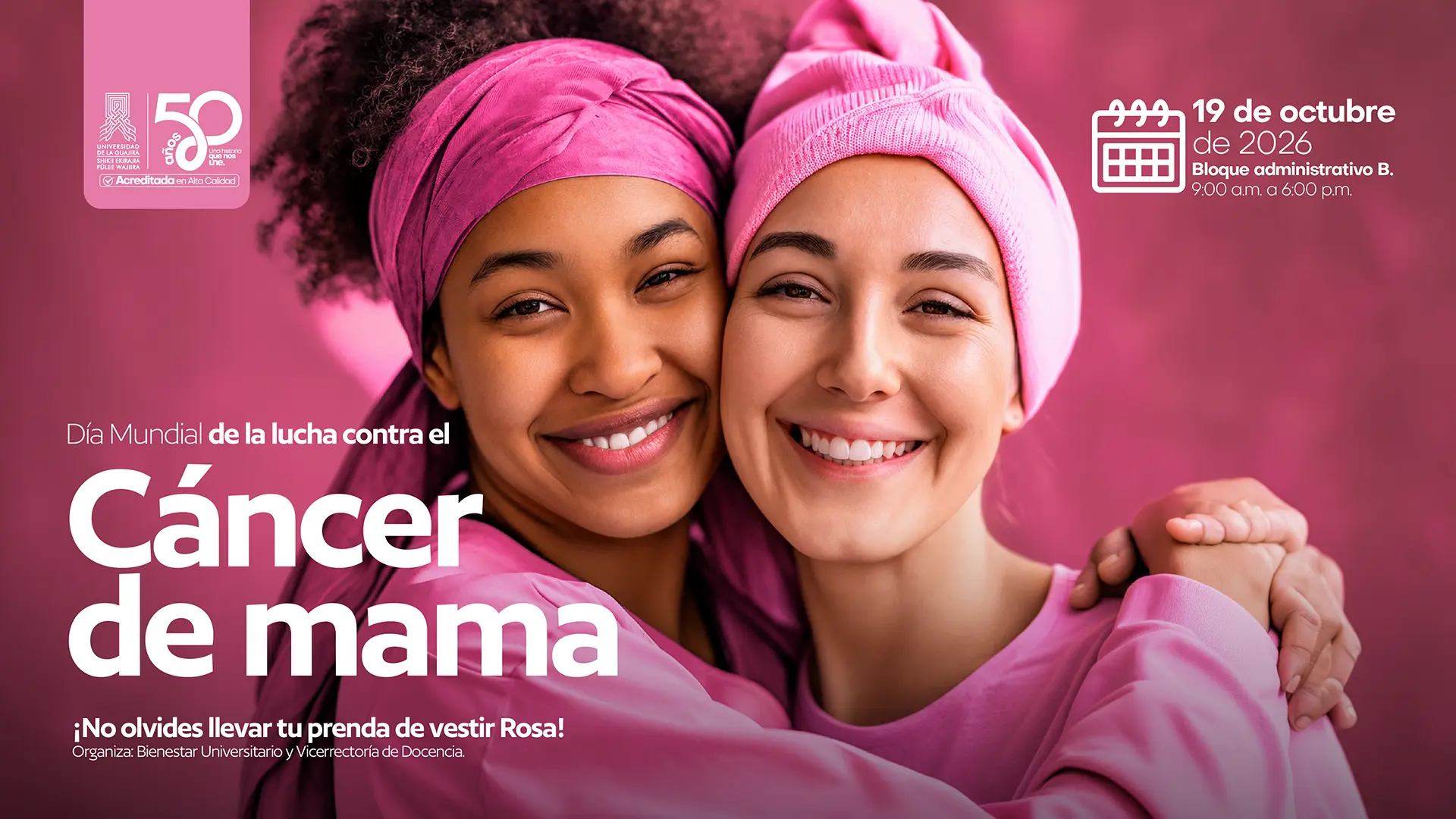 Pieza gráfica en tonos rosados alusiva al Día Mundial de la Lucha contra el Cáncer de Mama. En la imagen aparecen dos mujeres sonrientes, abrazadas y vestidas de rosa; una lleva un pañuelo en la cabeza y la otra un gorro rosado. El texto principal anuncia “Día Mundial de la lucha contra el Cáncer de mama” e invita a llevar una prenda de vestir rosa. La actividad se realizará el 19 de octubre de 2026, de 9:00 a. m. a 6:00 p. m., en el Bloque Administrativo B. La jornada es organizada por Bienestar Universitario y la Vicerrectoría de Docencia de la Universidad de La Guajira.